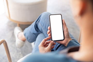 Wall Mural - cell phone blank white screen mockup.hand holding texting using mobile on desk at office.background empty space for advertise.work people contact marketing business,technology