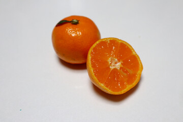 Poster - Ripe juicy cut and whole mandarins on the table