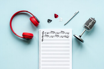 Wall Mural - Handwritten music sheets and headphones, top view. Compose music concept