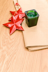 Poster - red wooden stars Christmas decoration and green candle on a wooden background