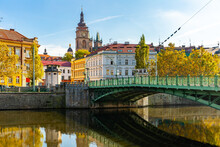 View Of Hradec Kralove Cityscape With Bridge Across Elbe River On Background With White Renaissance Tower And Belfries Of Gothic Cathedral On Sunny Autumn Day, Czech Republic.