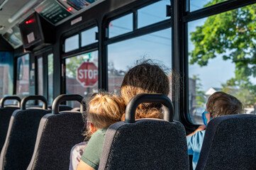 Single mother with children on the way to work in the morning on an empty bus