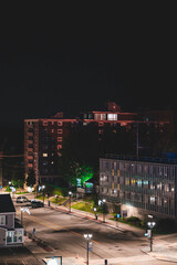 Sticker - Vertical shot of the buildings and the street with lights at night