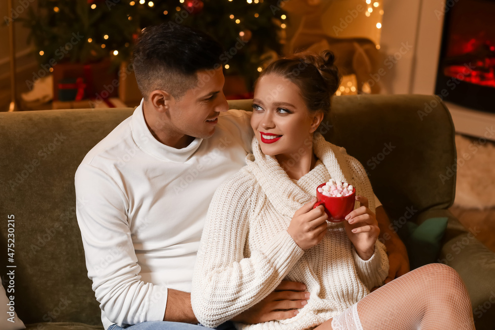 Happy young couple having romantic date on Christmas eve