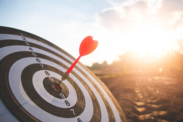Wall Mural - bullseye has red dart arrow throw hitting the center of a shooting for business targeting and winning goals business.