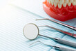Some dental instruments laying on a blue dental napkin