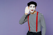Curious Nosy Charismatic Fun Young Mime Man With White Face Mask Wears Striped Shirt Beret Try To Hear You Overhear Listening Intently Isolated On Plain Pastel Light Violet Background Studio Portrait.