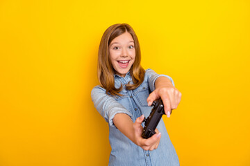 Canvas Print - Photo of hooray little brown hairdo girl playstation wear denim shirt isolated on bright yellow color background