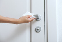 Cleaning Door Handles With An Antiseptic Wet Wipe And Gloves. Sanitize Surfaces Prevention In Hospital And Public Spaces Against Corona Virus. Woman Hand Using Towel For Cleaning Home Room Door Link