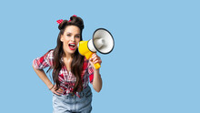 Cheerful Pinup Woman In Retro Style Clothes Making Announcement With Megaphone On Blue Studio Background