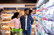 © Prostock-studio - Portrait of happy black family with trolley shopping together at grocery store