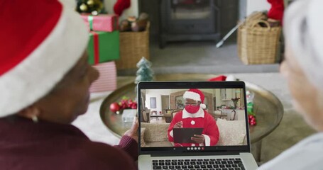 Poster - Diverse senior female friends using laptop for christmas video call with santa on screen