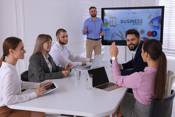 Sticker - Business trainer near interactive board in meeting room during presentation