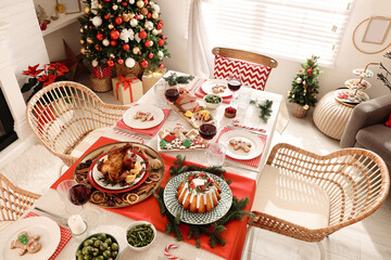 Poster - Festive dinner with delicious food and wine on table indoors, above view. Christmas Eve celebration