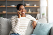 © Prostock-studio - Portrait Of Cheerful African American Female Talking On Mobile Phone At Home