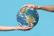 © Ivan - 3D Earth planet globe in man, woman hand, hands on blue background. Environmental protection concept. Elements of this image furnished by NASA