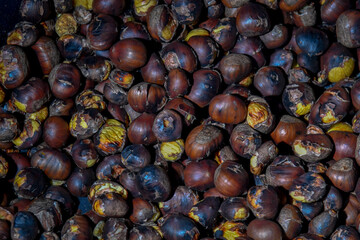 Sticker - Closeup of a heap of roasted chestnuts.