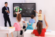 © New Africa - Teacher and pupil using interactive board in classroom during lesson