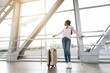© Prostock-studio - Travelling Concept. Happy African American Woman Standing Near Window In Airport Terminal