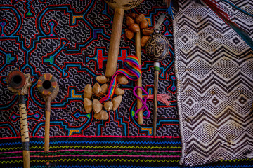 Sao Paulo, SP, Brazil - December 11 2021: Ceremony altar with shipibo fabric, florida water and Maracás Shipibo-Conibo of different models details.