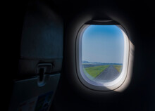 Looking At The Runway From The Airplane Window. Airplane Travel, Airplane Cabins And Windows, Long Journeys