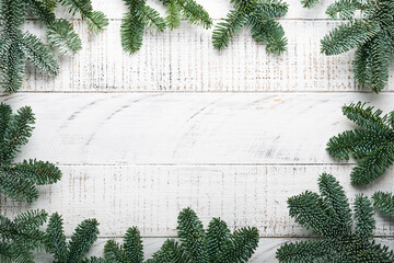 Wall Mural - Christmas Decoration. Holiday Decorations with gold baubles, cones, bells, fir branches and present on the old white wooden board background. Border design. Top view. Mock up.