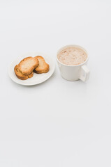 Sticker - delicious hot vegan Cappuccino with foam in a white cup with crispy biscuits on a white tabletop