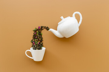 Wall Mural - Tea concept with white teapot and dry tea leaves