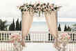 © Artem Zakharov - The wedding arch decorated with flowers stands in the luxurious area of the wedding ceremony.
