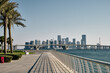 Empty seafront with the skyline view of Abu Dhabi city with high-rise buildings in the background