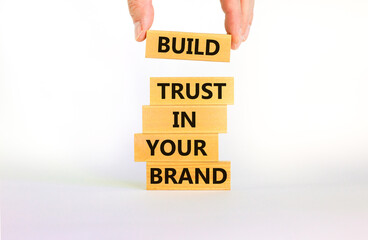 Wall Mural - Success business process symbol. Wood blocks stacking as step stair on beautiful white background, copy space. Businessman hand. Words 'build trust in your brand'. Business and trust brand concept.