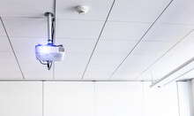A White Overhead Projector On Ceiling In A Conference Room/modern Classroom (color Toned Image)