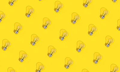 Wall Mural - light bulbs on yellow background in flat lay style.
