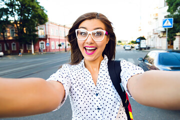 Wall Mural - Young hipster woman going crazy and having fun in city center of Europe