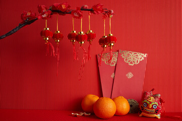 Wall Mural - Chinese new year festival decorations. Orange, leaf, red packet, plum blossom on red background.