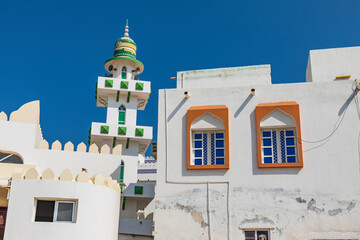 Wall Mural - Middle East, Arabian Peninsula, Oman, Al Batinah South. Small minaret above buildings in an Omani village.