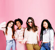© iordani - different nation girls with diversuty in skin, hair. Asian, scandinavian, african american cheerful emotional posing on pink background, woman day celebration, lifestyle people concept