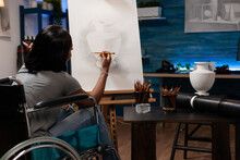 Art Student In Wheelchair Sketching Vase On Canvas Working At Artistic Ilustration Using Grahic Pencil During Painting Lesson In Creativity Home Studio. Young Woman Disability With Drawing Sketch