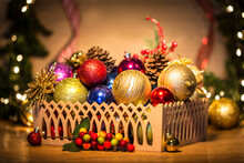 Basket With Colorful Christmas Balls And Pine Cones