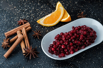 Poster - Closeup shot of dried cranberries decorated with cinnamon and orange slices