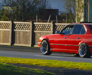 Sticker - Red car riding on the street.