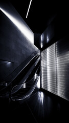 Sticker - Vertical shot of an escalator in a dark modern building