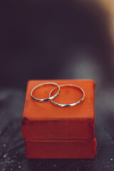 Sticker - Vertical closeup of wedding rings on the red box