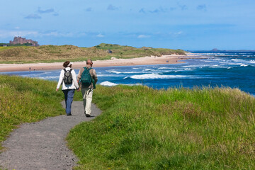 Sticker - Tourists hiking along the coast of Northumberland, England, UK