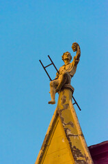 Canvas Print - Boy statue on top of the roof of an house in the old town, Riga, Latvia