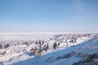 The snowy winter coastline and frozen white surface of Hudson Bay near Churchill, Manitoba, Canada.