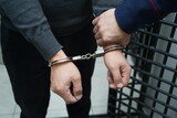 Fototapeta  - A police officer handcuffs a suspect