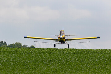 Sticker - Airplane spraying fungicide on a soybean field, Marion County, Illinois