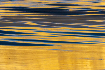 Sticker - Sunrise reflection on wet sand beach at Cape Kiwanda in Pacific City, Oregon, USA