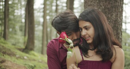 Poster - A Slow-motion of a South Asian romantic couple hugging each other for a photoshoot in the green park